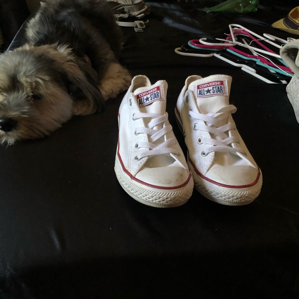 Fairly worn white converse.